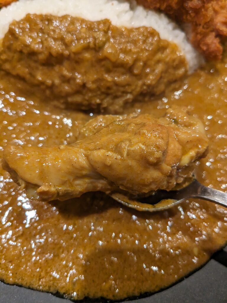三幸のカツカレーに入っていた手羽元のアップ。スプーンですくった状態